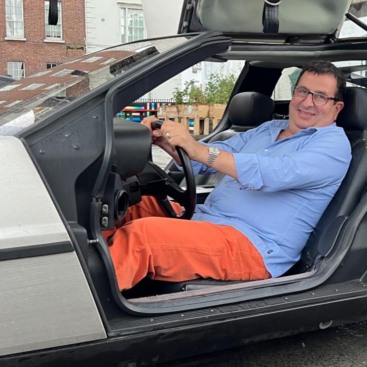 Haig Armaghanian in relaxes in the DeLorean at Data Hub building.
