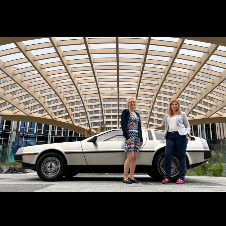 PharmaLex's Jane Lyons (Country Manager / European Regional Coordinator for QMC VDC) and Kate Coleman (Senior Director / Principal) take a break from their interview to admire the DeLorean.