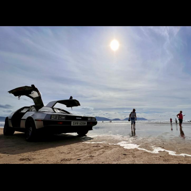 The DeLorean getting its feet wet with the other beachgoers at Inch Beach.