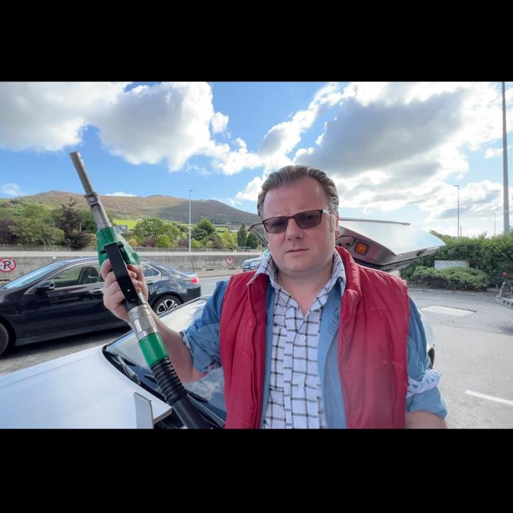 Nigel gives the DeLorean one last top up.