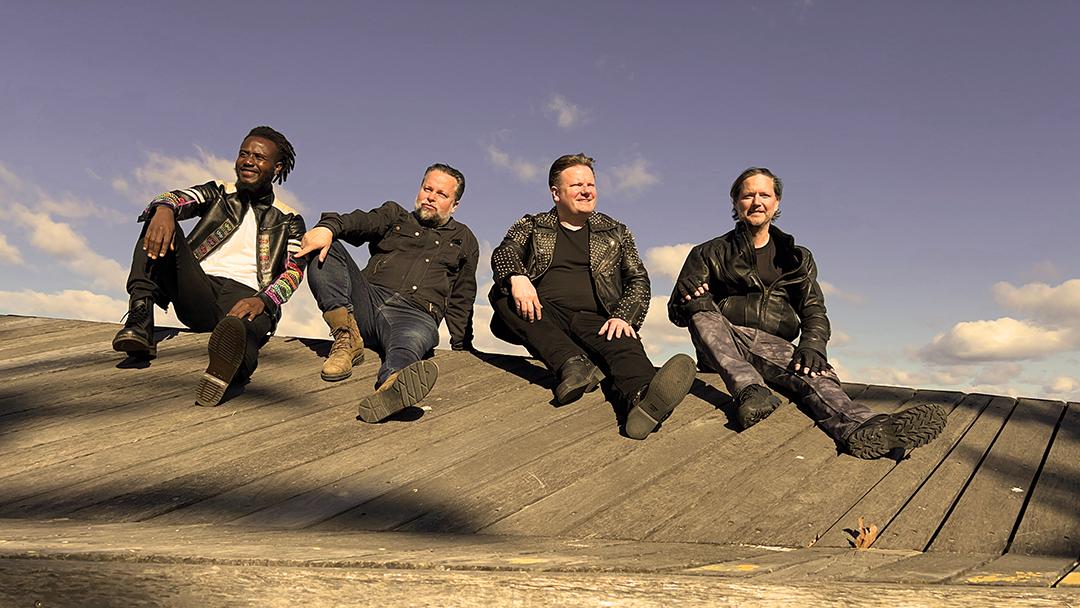 Adama, Mark, Nigel, and Lucas posing on the rooftop.