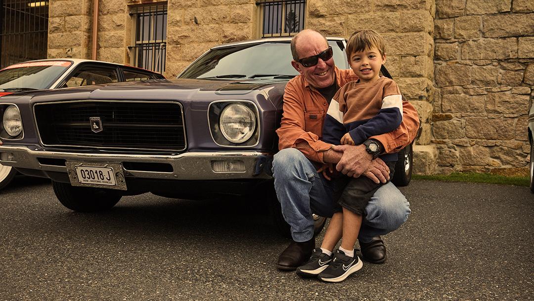 Glenn Oram and his driving companion. This car might be yours some day, little man.